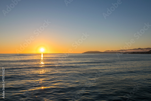 Fototapeta Naklejka Na Ścianę i Meble -  Waiting for the Sun to set at Pismo Beach, Oceano Dunes Natural Preserve, California, USA