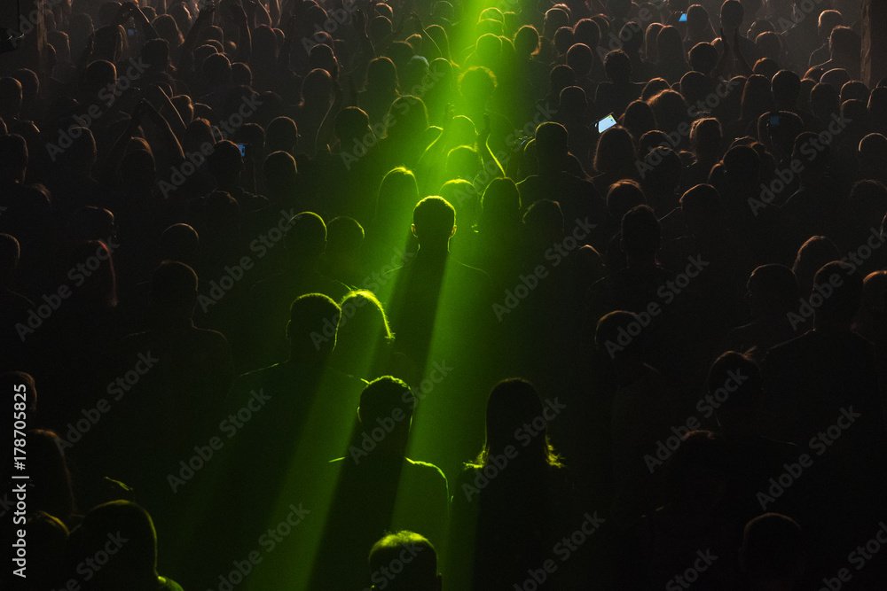 Rock concert crowd people in front of the bright stage lights Stock