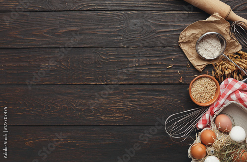Baking background with eggs and flour on rustic wood