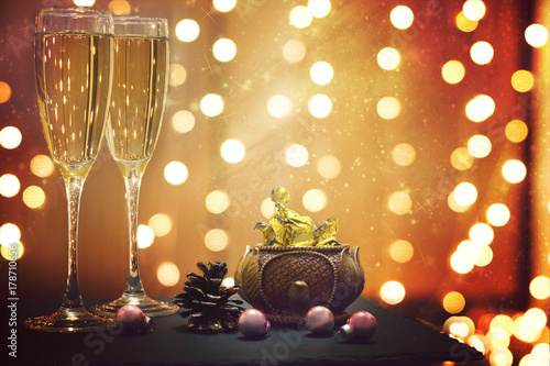 Glowing festive garland and champagne with candies on its background photo