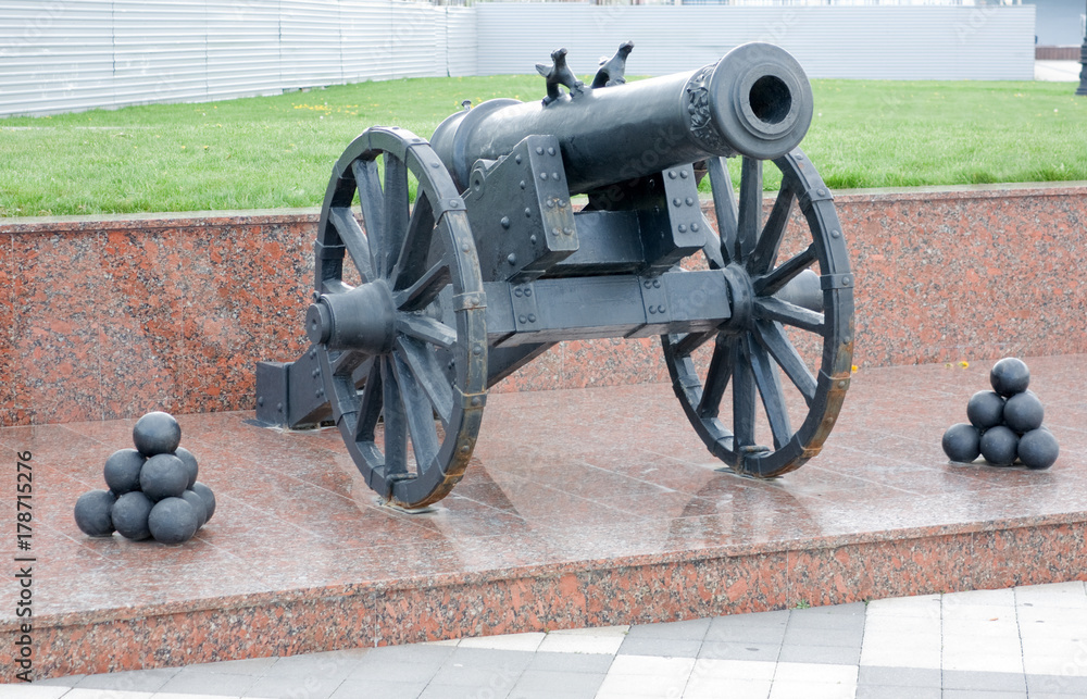An old cannon on a granite pedestal An old cannon on a granite pedestal
