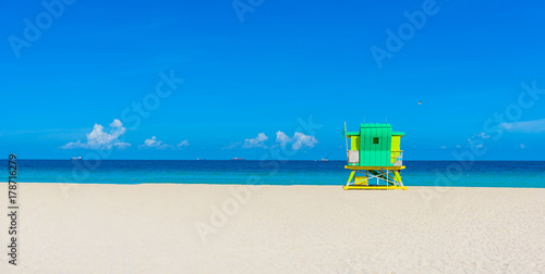 Miami South Beach, lifeguard house in a colorful Art Deco style at sunny summer day with the Caribbean sea in background, world famous travel location in Florida, USA photo
