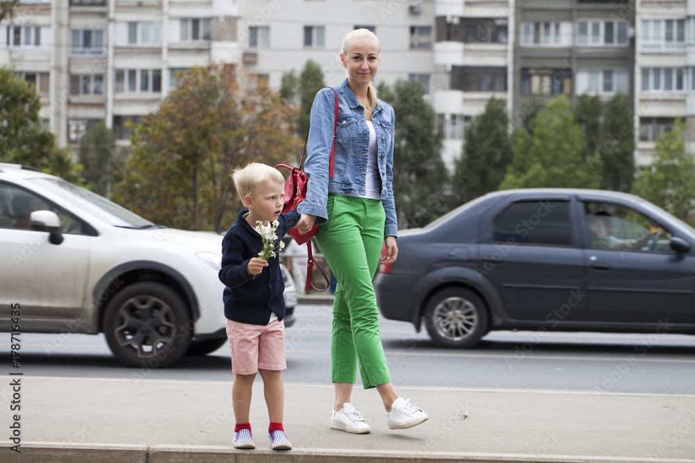 Mother and son on the road waiting for public transport Mother and son on the road waiting for public transport