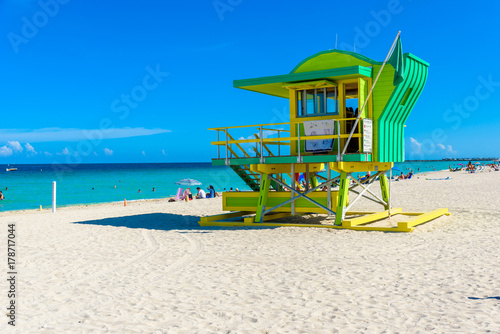 Miami South Beach, lifeguard house in a colorful Art Deco style at sunny summer day with the Caribbean sea in background, world famous travel location in Florida, USA