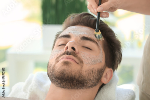 Beautician applying scrub o...