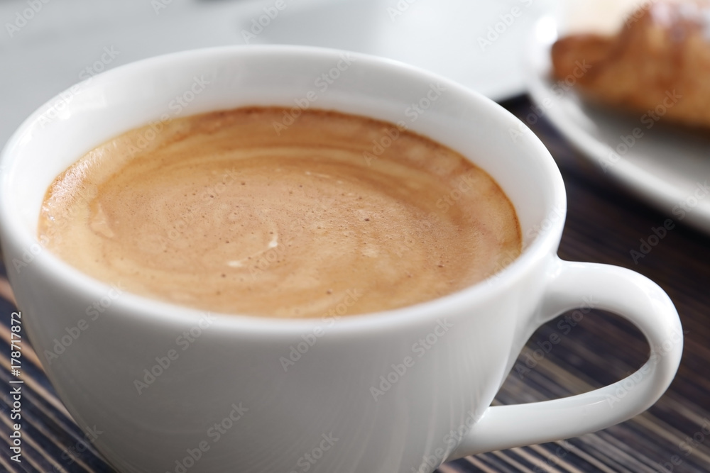 Cup of aromatic morning coffee on wooden table Cup of aromatic morning coffee on wooden table