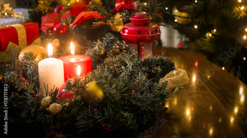 Closeup image of burning candles and Advent wreath at living room © Кирилл Рыжов