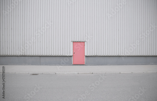 Фотография Gray building with red door