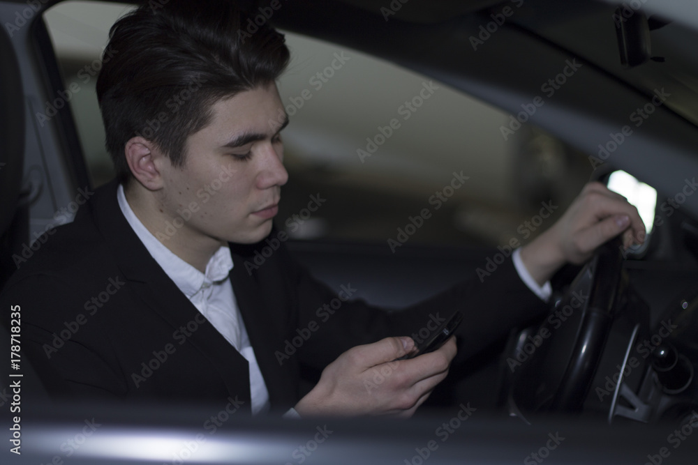 man repairing his car on the phone