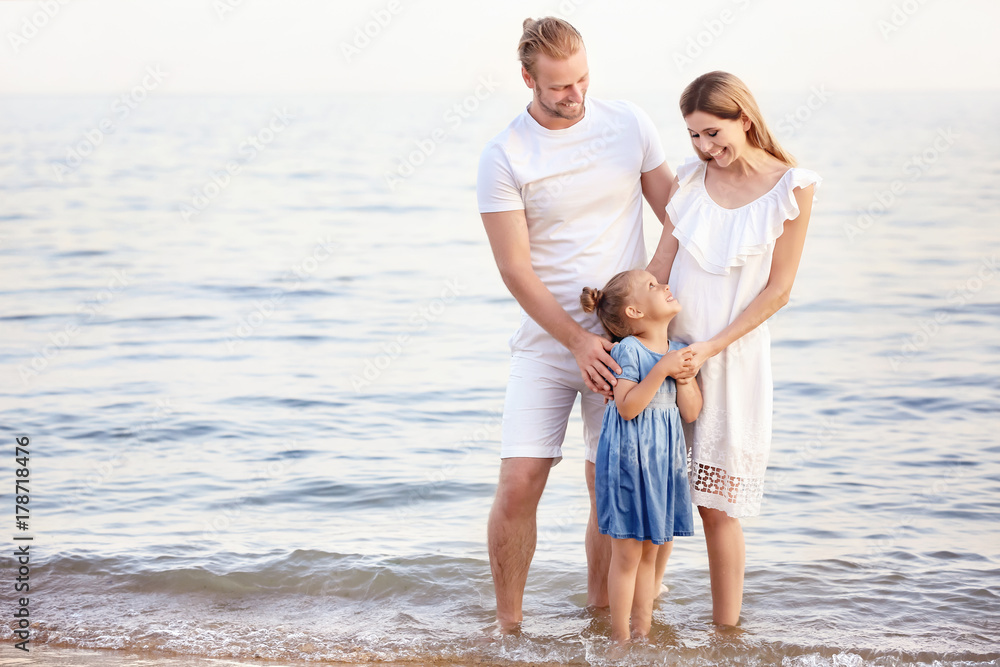 Happy family on sea beach at resort Happy family on sea beach at resort