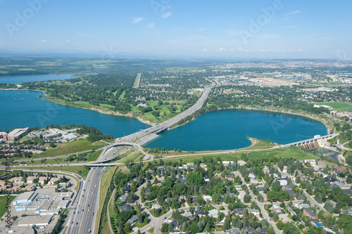 Aerial view of a city and highway running through man made reservoir. Calgary, Alberta, Glenmour Reservoir. 