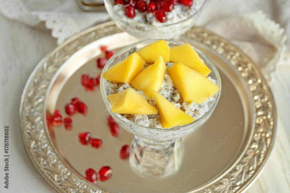 Glass dessert bowl with delicious chia seed pudding on metal tray Glass dessert bowl with delicious chia seed pudding on metal tray