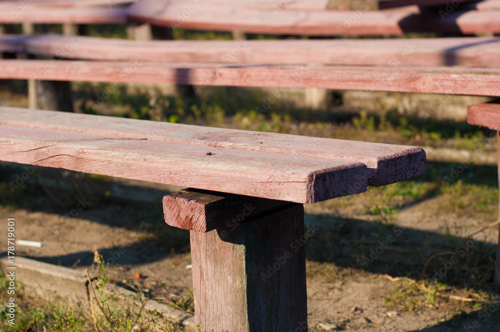 Fragment of old wooden benches outdoors
