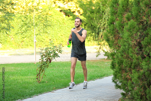 Young man running in park