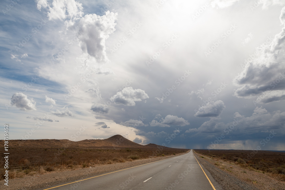 approaching storm clouds on open road