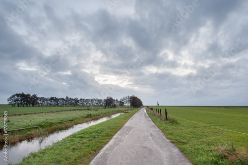 hiking trail next to the meadow with Stratus Clouds