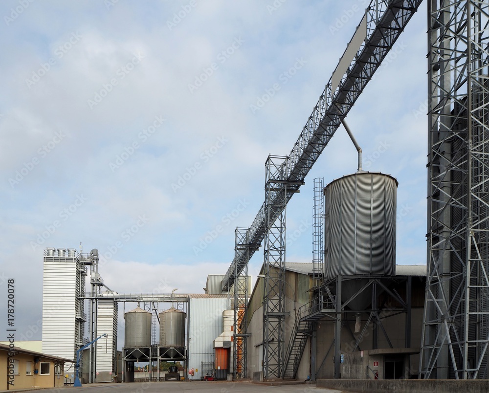Cereal silos, drying towers and pipes in an industrial agricultural plant Cereal silos, drying towers and pipes in an industrial agricultural plant