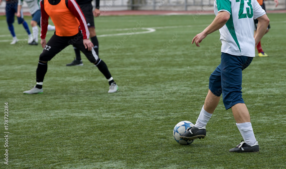  Young Soccer Players Running After the Ball.