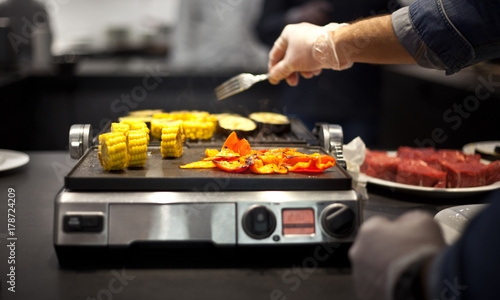 grilled vegetables on the grill. chef of the restaurant. hot vegetables. cooking on the grill. grilled vegetables. bbq.