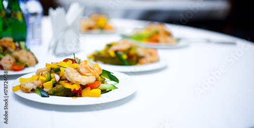 grilled salad with shrimps. plates with salad. delicious. bright salad. restaurant food. a delicacy.