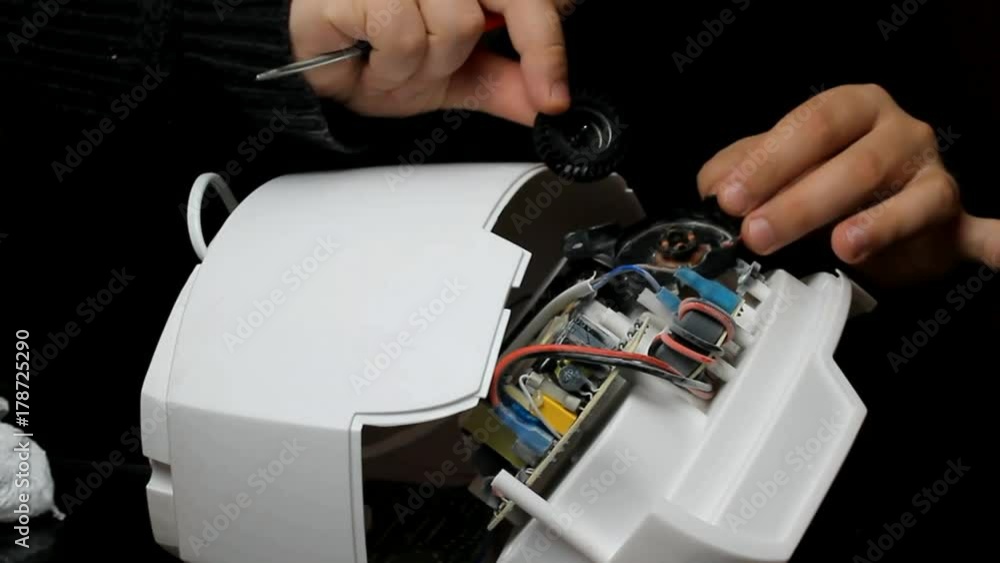 Man repairs and lubricates the cooler of technology. repair of the cooling system, fan cleaning and lubrication of parts with oil, for the effective operation of air removal. Humidifier repair Man repairs and lubricates the cooler of technology. repair of the cooling system, fan cleaning and lubrication of parts with oil, for the effective operation of air removal. Humidifier repair