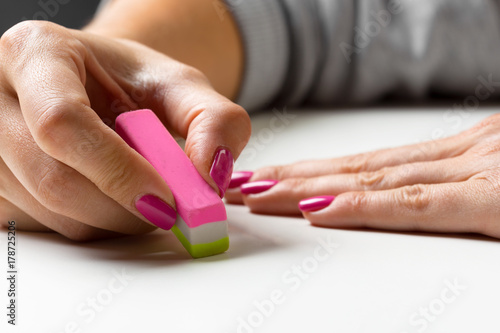 side view of hand with rubber eraser