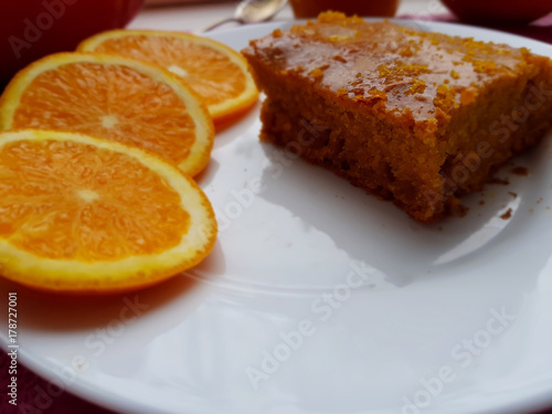 A piece of a homemade orange cake for breakfast, closeup