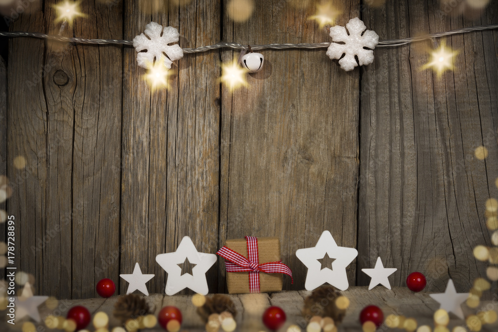 christmas gift and stars on old wooden background christmas gift and stars on old wooden background