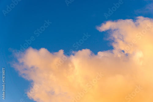 orange clouds in front of blue sky 