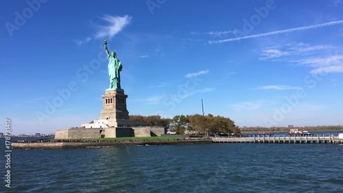 View of the Statue of Liberty from the New York Harbor on a clear autumn day
