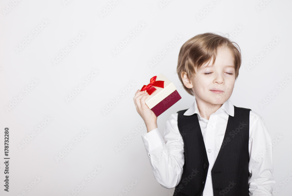 Happy young blond boy with present box isolated on white background. Happy young blond boy with present box isolated on white background.