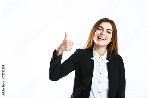 Beautiful caucasian brunette businesswoman wears black jacket show thumb up sign on white isolated background with copyspace © proimagecontent