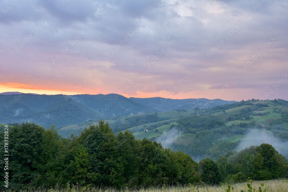 Evening and sunset on mountain hills of a romanian village