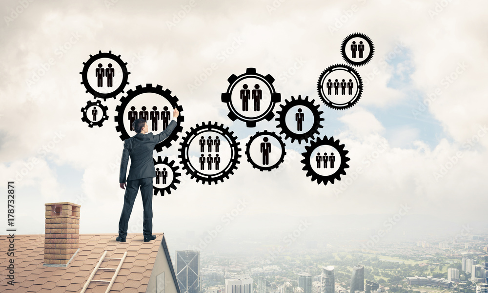 Businessman on house roof presenting teamwork and connection con Businessman on house roof presenting teamwork and connection con
