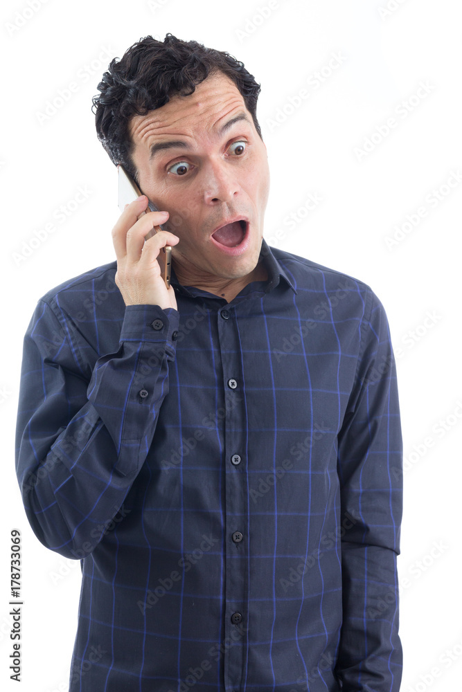 Worker receives shocking news. Cell phone. The person is wearing dark blue social shirt. Isolated.. Worker receives shocking news. Cell phone. The person is wearing dark blue social shirt. Isolated..