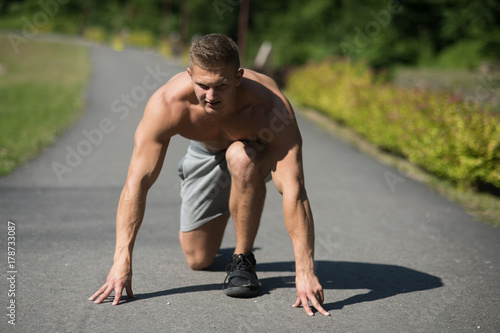 Man on start position to run on road
