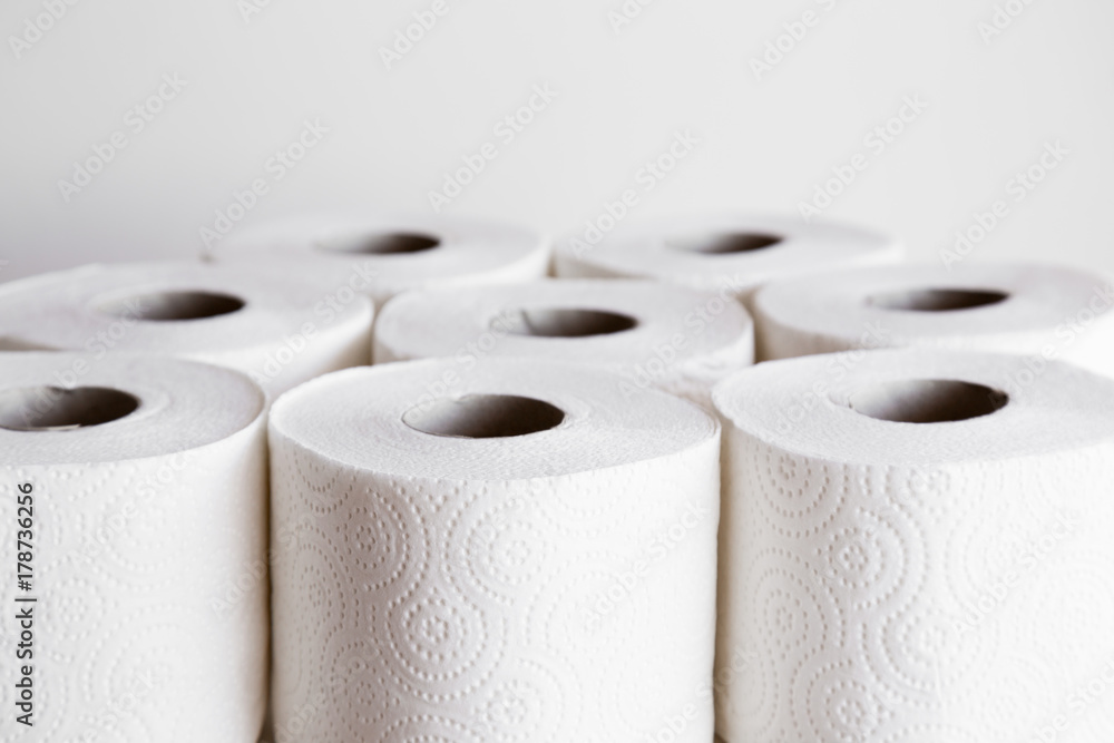 White toilet paper rolls on the gray background. Hygiene concept. White toilet paper rolls on the gray background. Hygiene concept.