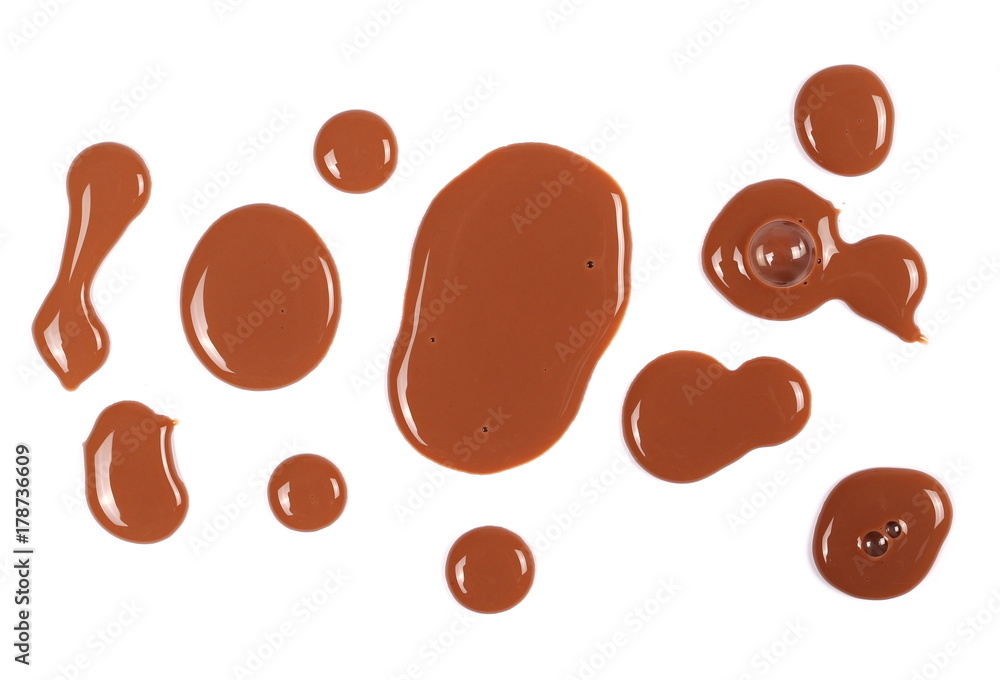 Spilled chocolate milk puddle isolated on white background, top view Spilled chocolate milk puddle isolated on white background, top view