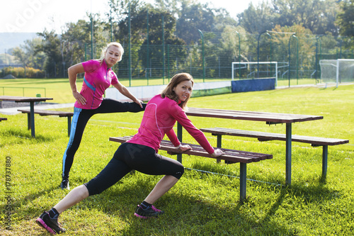 Two women doing stretching exercise 