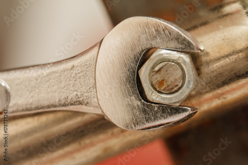 Metal nut And Chrome-Vanadium Spanner Gripping Isolated On blurred Background