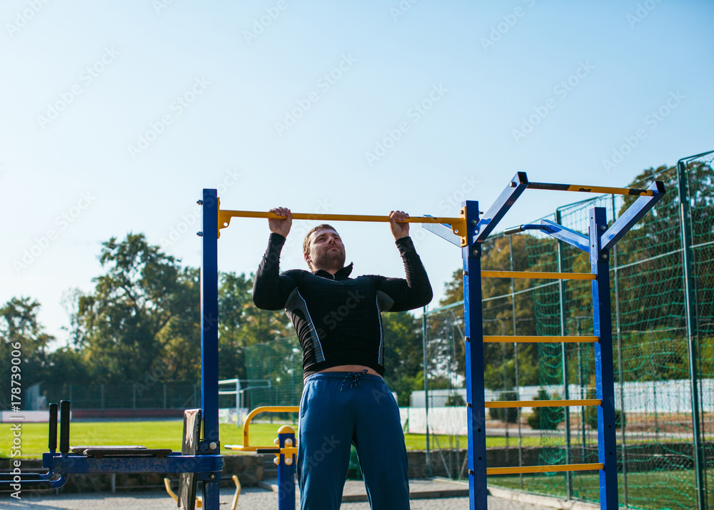 Fototapeta premium The man workout on the crossbar