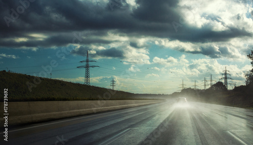 rainy highway with car in fog water spray © AA+W