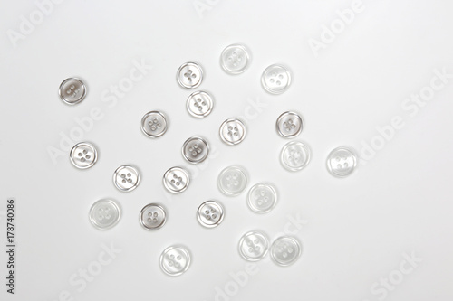 buttons scattered on a white background.