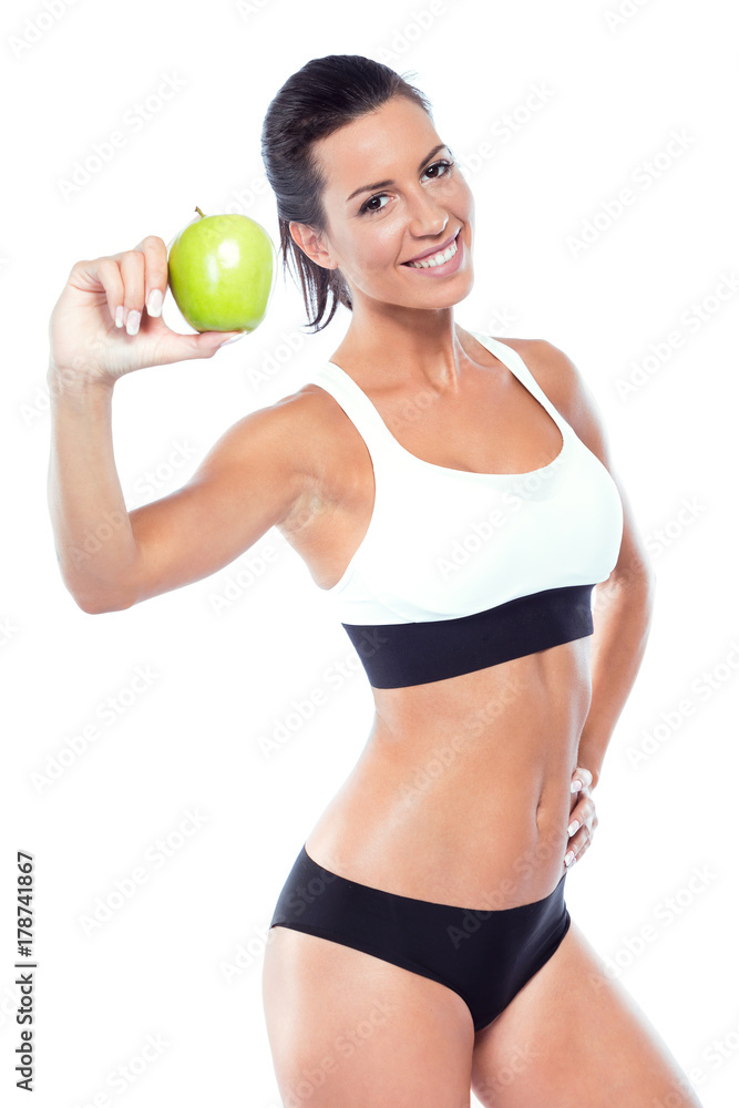 Beautiful young woman eating an apple over white background. Beautiful young woman eating an apple over white background.