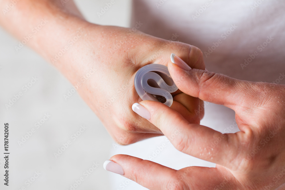 Fototapeta premium menstrual cup in female hands