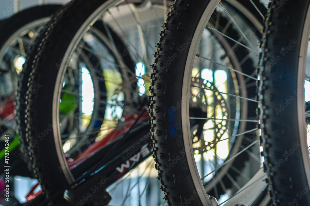 Close up on detail of modern bicycles. Sports shop, factory warehouse, repair station workshop abstract mobility technology background.