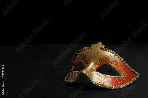 Golden Mardi Gras or Carnival mask isolated on a black background