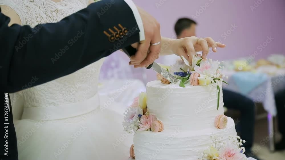 Detail of wedding cake cutting by newlyweds Wedding cake Detail of wedding cake cutting by newlyweds Wedding cake