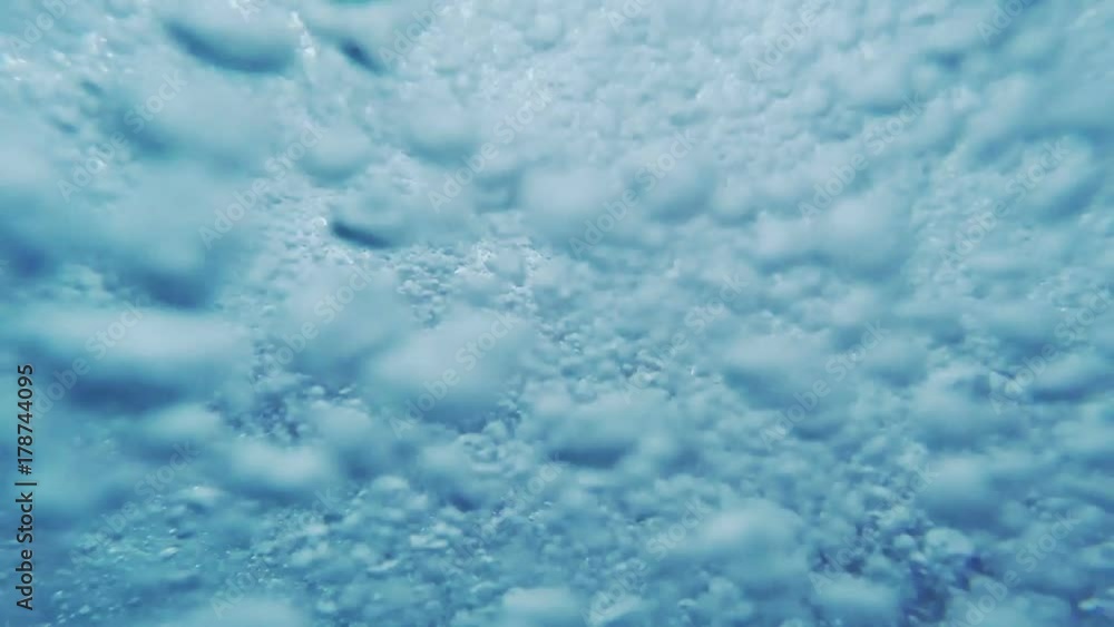 Underwater sea bubbles and foam with sunlight rays, natural background Underwater sea bubbles and foam with sunlight rays, natural background