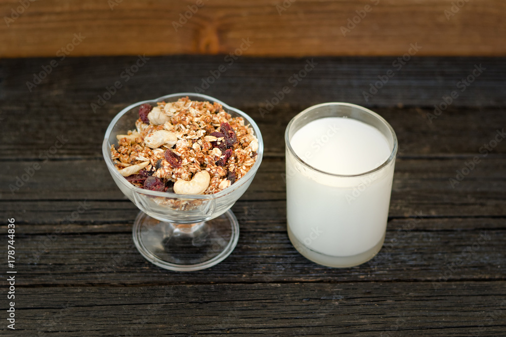 Glass of yogurt and granola on a black wooden table. Traditional American Breakfast Glass of yogurt and granola on a black wooden table. Traditional American Breakfast